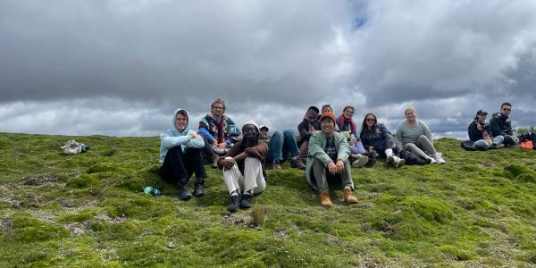 Students in thesitting dow taking a break from hiking a mountain in the Andes of Ecuador. 