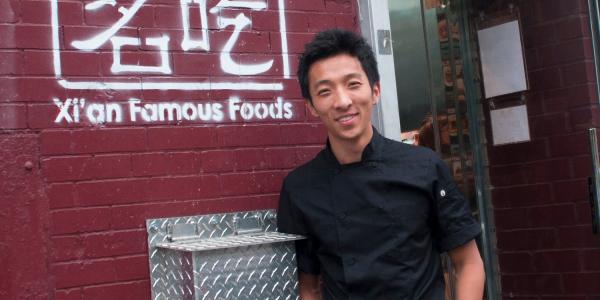 Jason Wang in front of Xian Famous Foods store front