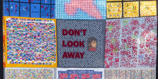 photo of one of the quilts composed of images representing migrant detention
