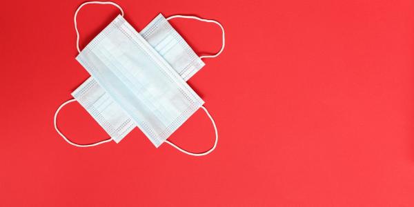 Medical masks on red background