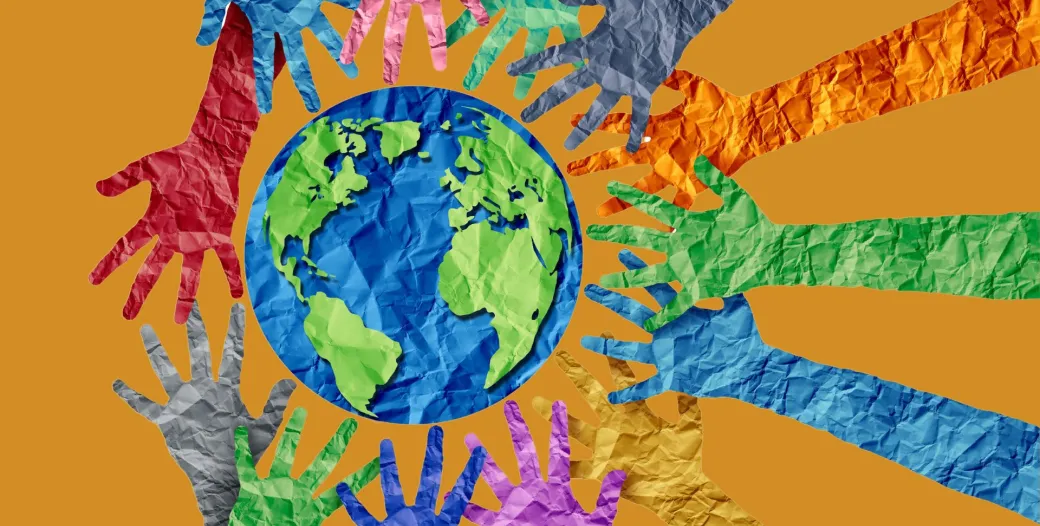 color paper image of a globe and hands reaching towards it from all directions on a dark orange background